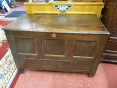 AN ANTIQUE OAK COFFER, the three plank moulded edge top lifting to reveal an interior candle box,