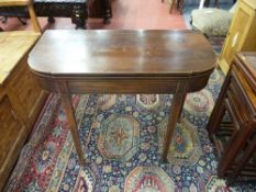 A GEORGIAN MAHOGANY FOLDOVER TEA TABLE, the shaped sides with boxwood stringing and strung inlaid