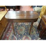 A GEORGIAN MAHOGANY FOLDOVER TEA TABLE, the shaped sides with boxwood stringing and strung inlaid