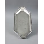 AN OBLONG SILVER PEN TRAY of shaped form with decorative banding and crest to the base, 4 troy