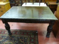 A VICTORIAN CARVED OAK LIBRARY TABLE, the rectangular leaf carved edge top over a carved frieze with