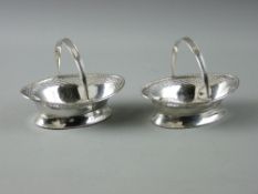 A PAIR OF OVAL BON BON DISHES with bead and latticed borders and swing handles, 4.3 troy ozs,