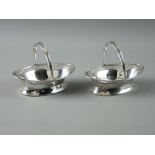 A PAIR OF OVAL BON BON DISHES with bead and latticed borders and swing handles, 4.3 troy ozs,