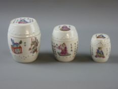 THREE CHINESE PORCELAIN GRADUATING BARREL SHAPED LIDDED POTS, circa 1900, decorated with various