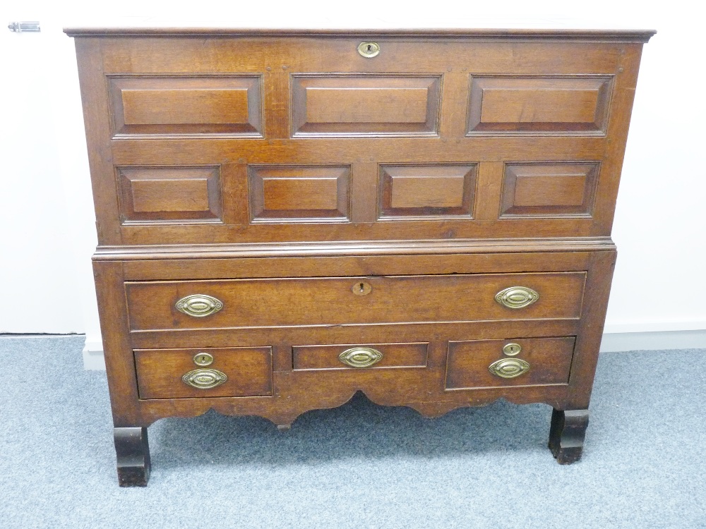 A GEORGE III OAK MULE CHEST, well coloured peg-joined construction with lidded top over a seven