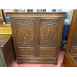 A 20th CENTURY CARVED CUPBOARD with single base drawer having reeded frieze decoration and sides,