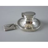 A HALLMARKED SILVER STAMP ENVELOPE and a capstan inkwell, the envelope with chased decoration, the