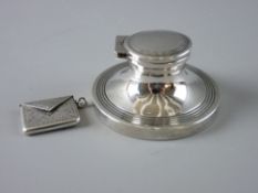 A HALLMARKED SILVER STAMP ENVELOPE and a capstan inkwell, the envelope with chased decoration, the