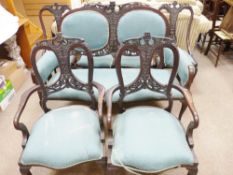 AN EDWARDIAN MAHOGANY SEVEN PIECE SALON SUITE of two seater couch, two armchairs and four side