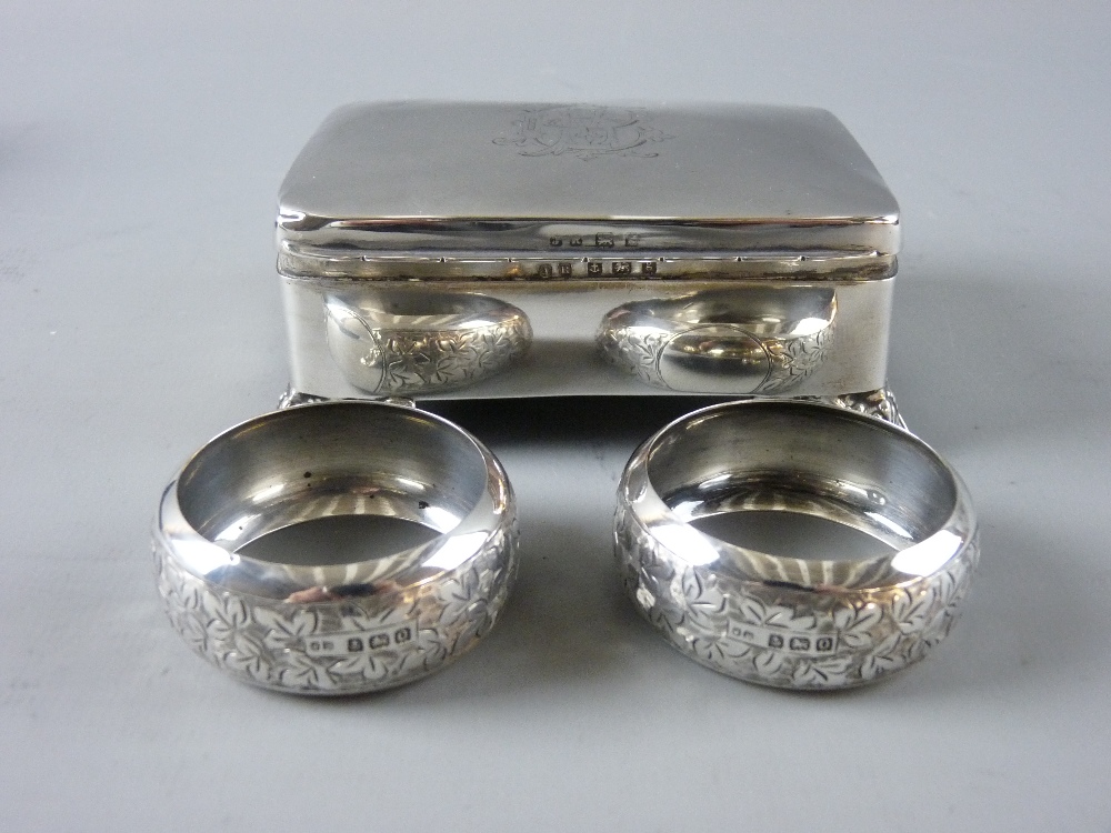 A HALLMARKED SILVER TRINKET BOX and a cased pair of napkin rings, the rectangular box with
