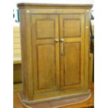 AN OAK AND CROSSBANDED MAHOGANY TWO DOOR HANGING CORNER CUPBOARD, early 19th Century flat fronted,