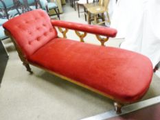 A LATE VICTORIAN WALNUT CHAISE LONGUE having a red dralon buttoned end with long arm rest and with