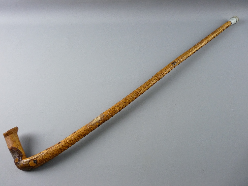 A NATURAL WOOD WALKING STICK carved in Welsh with the Ten Commandments, 93 cms long