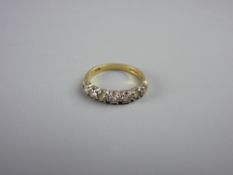 AN EIGHTEEN CARAT GOLD SEVEN STONE DIAMOND RING, size 'K', 2.7 grms