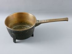 AN ANTIQUE BRONZE THREE FOOTED SKILLET PAN, 22 cms diameter, the handle marked 'W H 4'