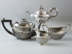 A THREE PIECE ELECTROPLATED TEA SERVICE of oval reeded form and a Continental electroplated teapot