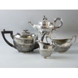 A THREE PIECE ELECTROPLATED TEA SERVICE of oval reeded form and a Continental electroplated teapot