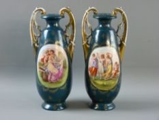 A PAIR OF VICTORIA AUSTRIA TWIN HANDLED VASES, green ground with oval figural panels, 27 cms high