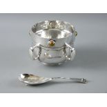 A LIBERTY & CO CYMRIC SILVER FOUR HANDLED BOWL having an inset circular agate between each of the
