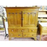 AN EARLY TO MID 19th CENTURY OAK PRESS CUPBOARD, the inverted cornice over two twin panel doors with