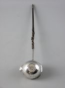 A SILVER PUNCH LADLE with coin base, 1764 and with a whale bone twist handle