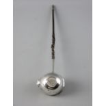 A SILVER PUNCH LADLE with coin base, 1764 and with a whale bone twist handle