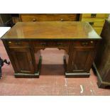 AN EDWARDIAN MAHOGANY KNEEHOLE DESK BASE having three frieze drawers and pedestal cupboard doors