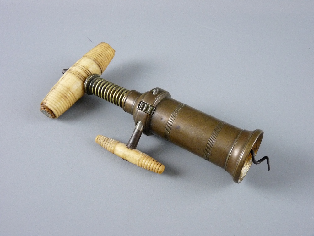 A VICTORIAN DOWLER PATENT BRASS CORKSCREW with turned bone grip and ratchet side handle, 20 cms long