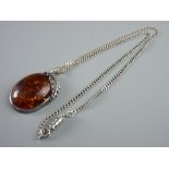 AN OVAL, POSSIBLY RUSSIAN AMBER, PENDANT with leaf adorned frame and a silver curb chain, total 23.5