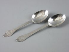 TWO CONTINENTAL SILVER, POSSIBLY DUTCH SERVING SPOONS, each with primitive decoration to the
