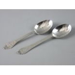 TWO CONTINENTAL SILVER, POSSIBLY DUTCH SERVING SPOONS, each with primitive decoration to the