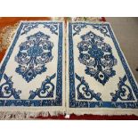 A MATCHING PAIR OF MODERN TIBETAN HANDMADE INDIAN RUGS with blue pattern centres and borders on a