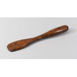 A NINETEENTH CENTURY FRUITWOOD TREEN SPATULA, 26cms long