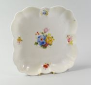 A NANTGARW PORCELAIN SQUARE DISH of lobed form and painted with a centre spray of flowers and four