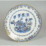 A SWANSEA PORCELAIN ELEPHANT PATTERN TEA-PLATE in blue and white with gilding, 21cms diam