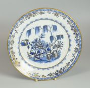 A SWANSEA PORCELAIN ELEPHANT PATTERN TEA-PLATE in blue and white with gilding, 21cms diam