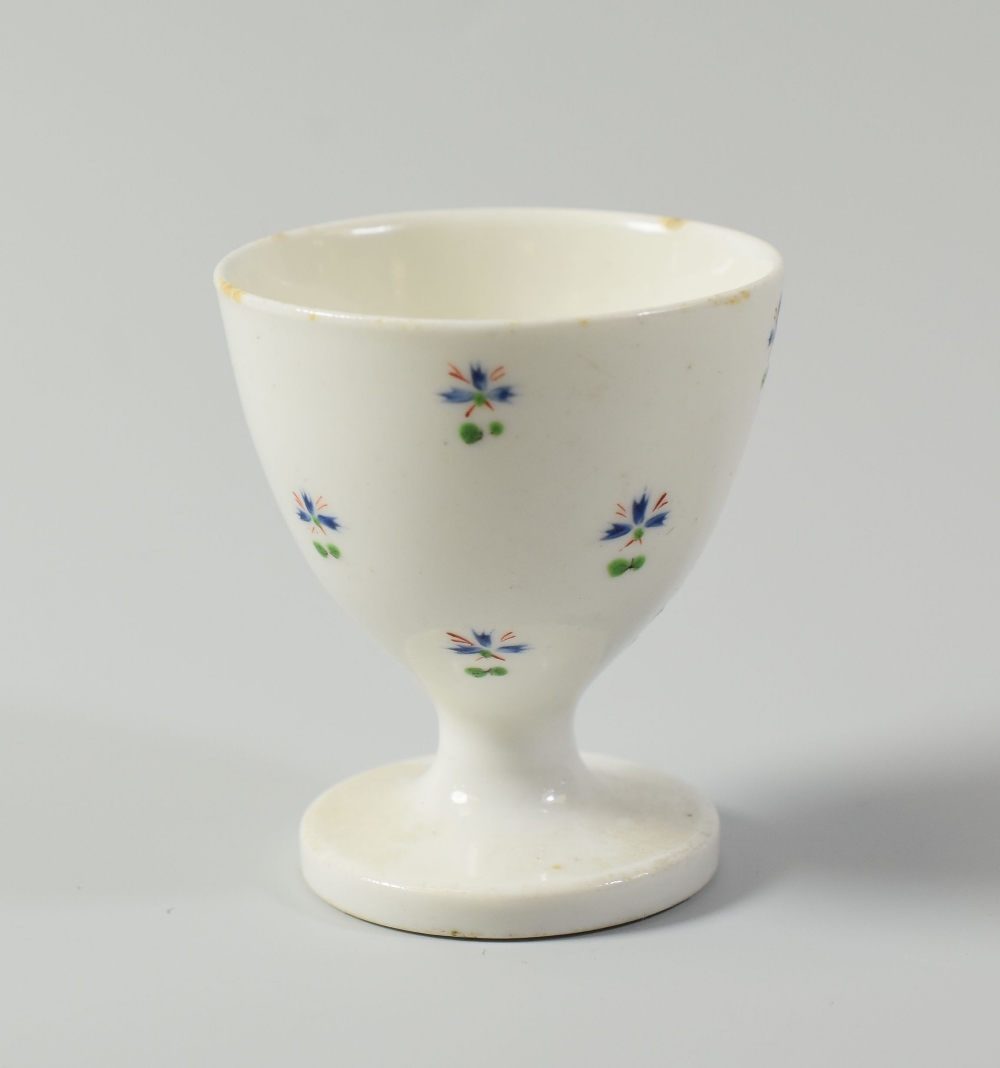 A RARE SWANSEA PORCELAIN EGG-CUP decorated with isolated cornflower heads, stencilled SWANSEA mark