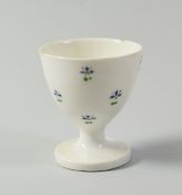 A RARE SWANSEA PORCELAIN EGG-CUP decorated with isolated cornflower heads, stencilled SWANSEA mark