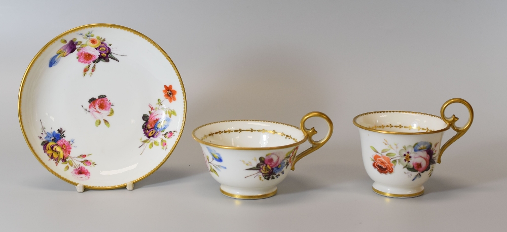 A NANTGARW PORCELAIN TRIO circa 1820, with gilded loop handles, gilt dentil rims and finely