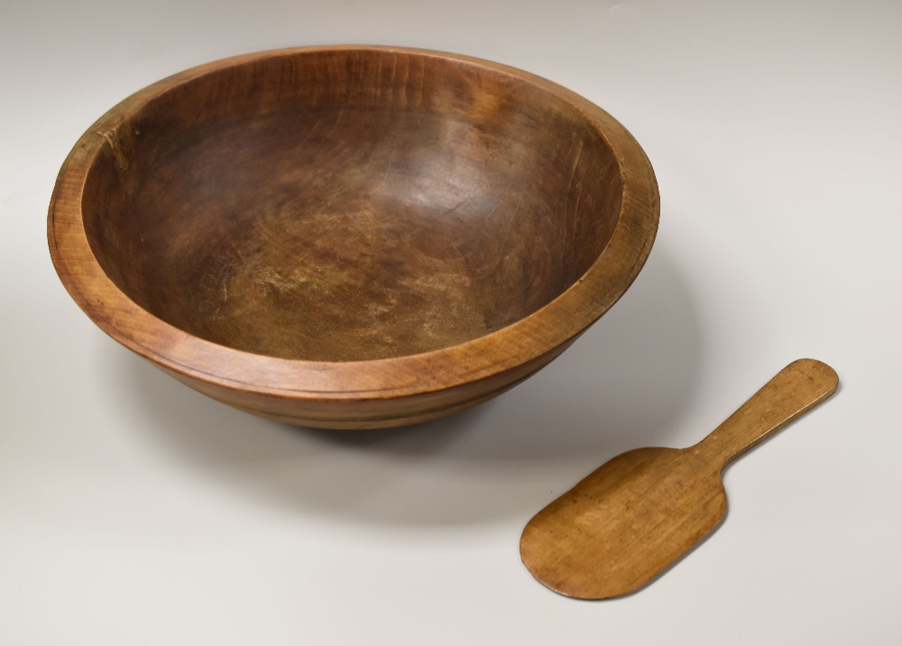 A WELSH SYCAMORE TREEN DAIRY BOWL, 43cms diam together with a simple undecorated butter pat, 30cms