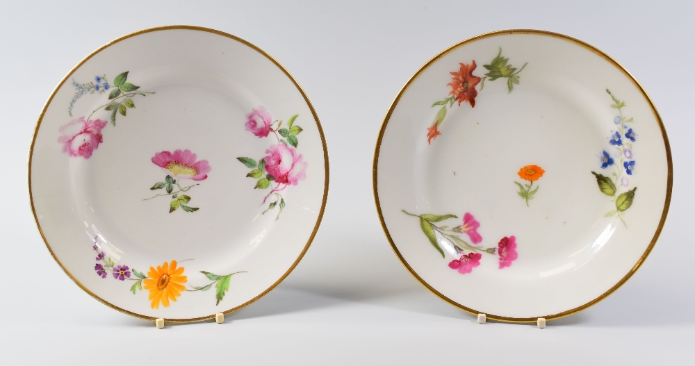 A PAIR OF SWANSEA PORCELAIN PLATES circa 1818, with gilded edges and painted flower sprays,