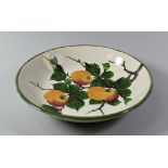 A SHALLOW LLANELLY POTTERY APPLE DISH with three painted fruit in branches with leaves, LLANELLY