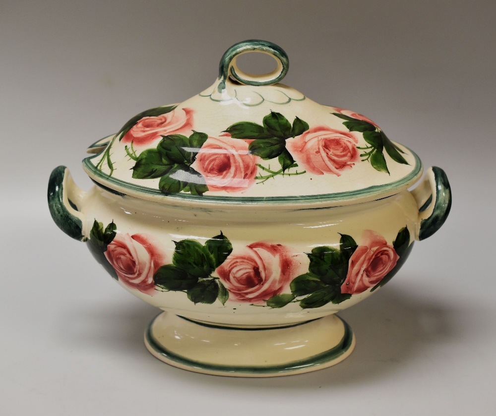 A LLANELLY POTTERY HYBRID TEA-ROSE DECORATED TUREEN of oval footed form with loop handle to the