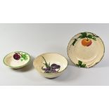 THREE ITEMS OF LLANELLY POTTERY comprising plum decorated fruit dish, bowl with irises and plate