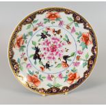 A SWANSEA PORCELAIN ORIENTAL STYLE PLATE circa 1818, with border of gilt foliage and pink flowers on