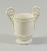 A NANTGARW PORCELAIN UNDECORATED CABINET CUP with double gryphon handles and tapering to the