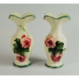 A PAIR OF LLANELLY POTTERY VASES of faceted form with opening out waisted necks, decorated with