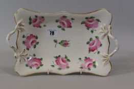 A SWANSEA PORCELAIN TWIG-HANDLED DISH painted with a sequence of open pink roses and a single closed