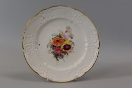 A NANTGARW PORCELAIN PLATE of alternate lobed form and moulded with C-scrolls, flowers and