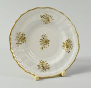 A SWANSEA PORCELAIN EGG CUP SAUCER of lobed circular form, with basket weave moulding to the